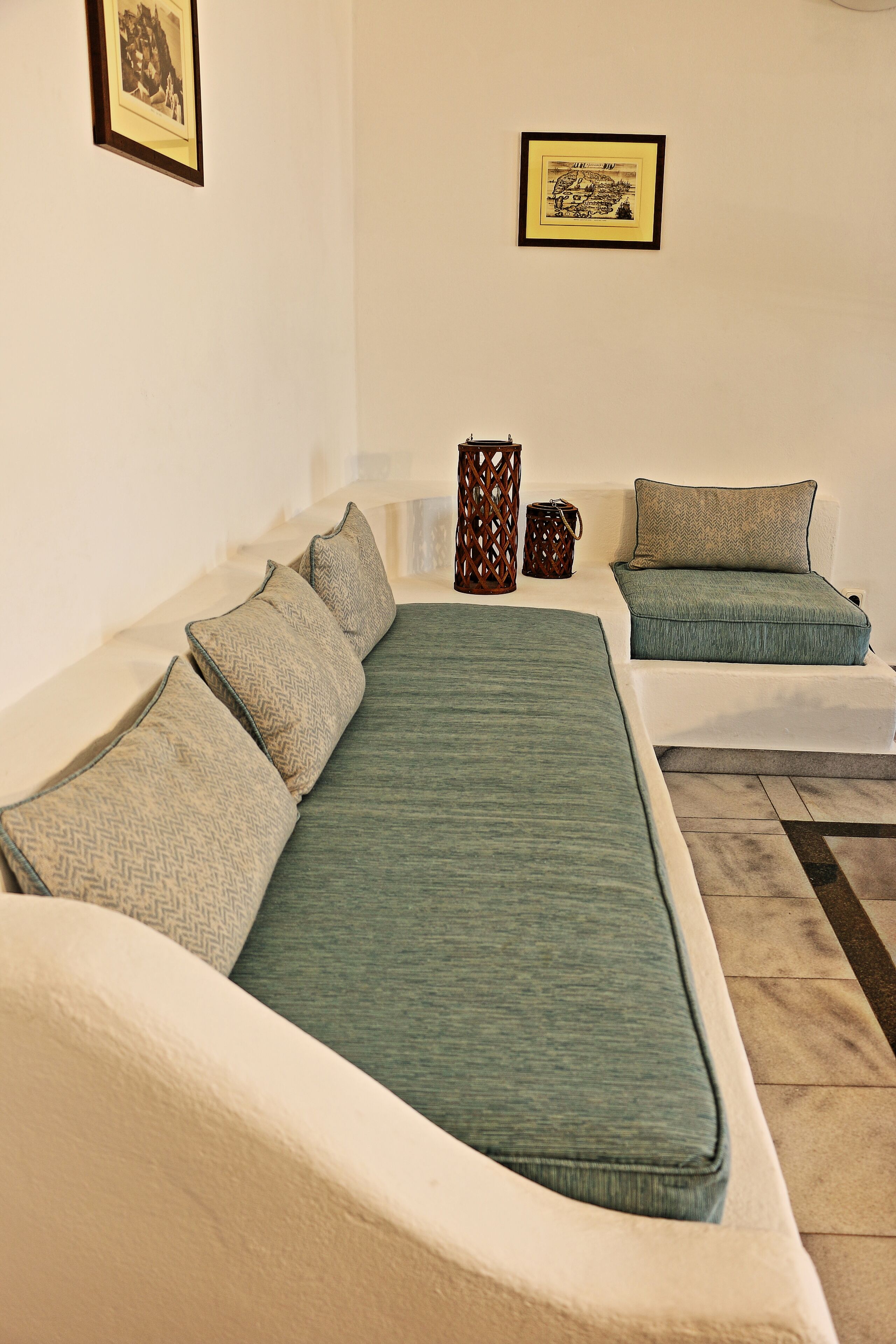 A modern living room with a sofa set, a coffee table, and decorative items.
