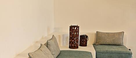 A modern living room with a sofa set, a coffee table, and decorative items.