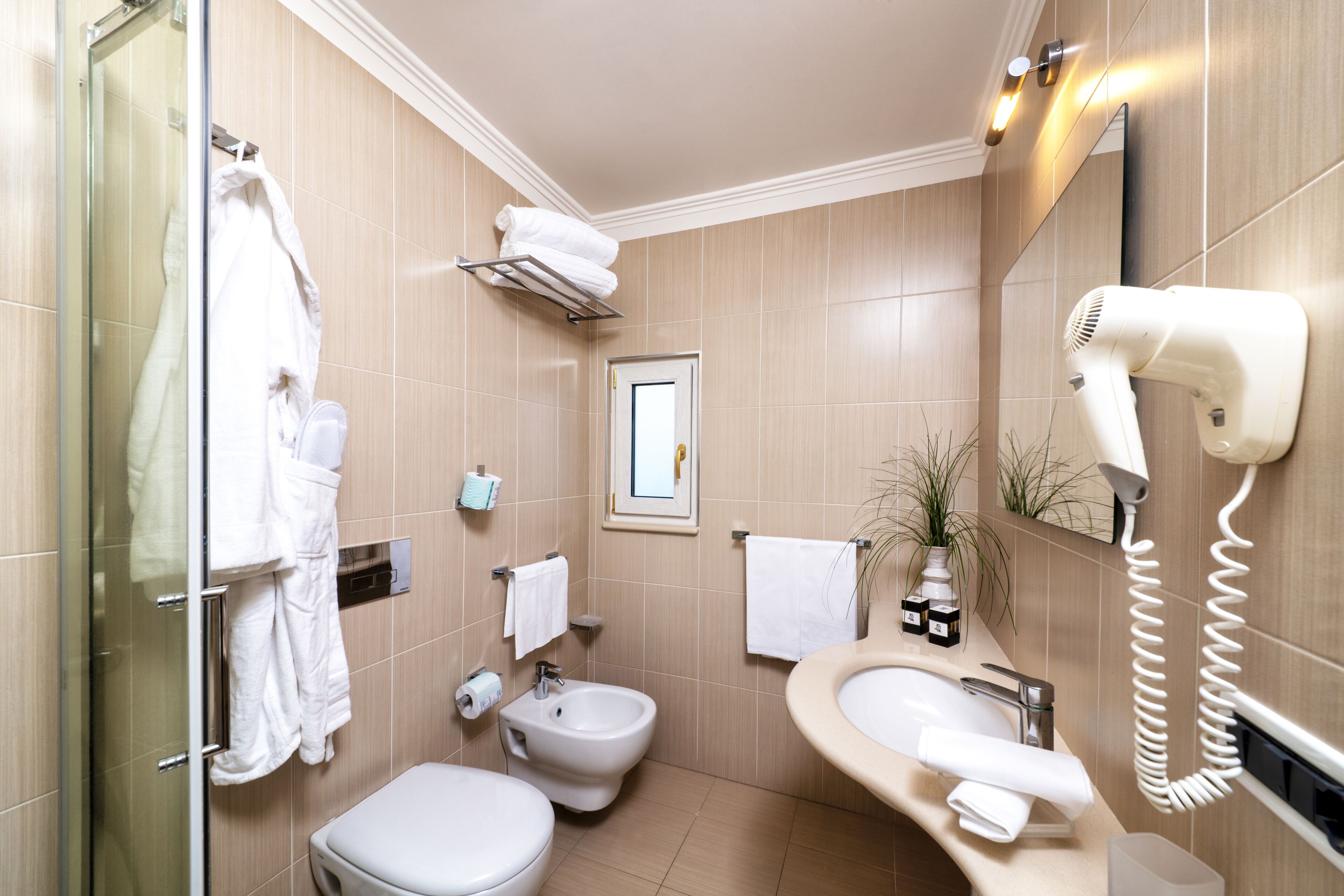 eco-friendly toiletries, slippers, bidet, towels