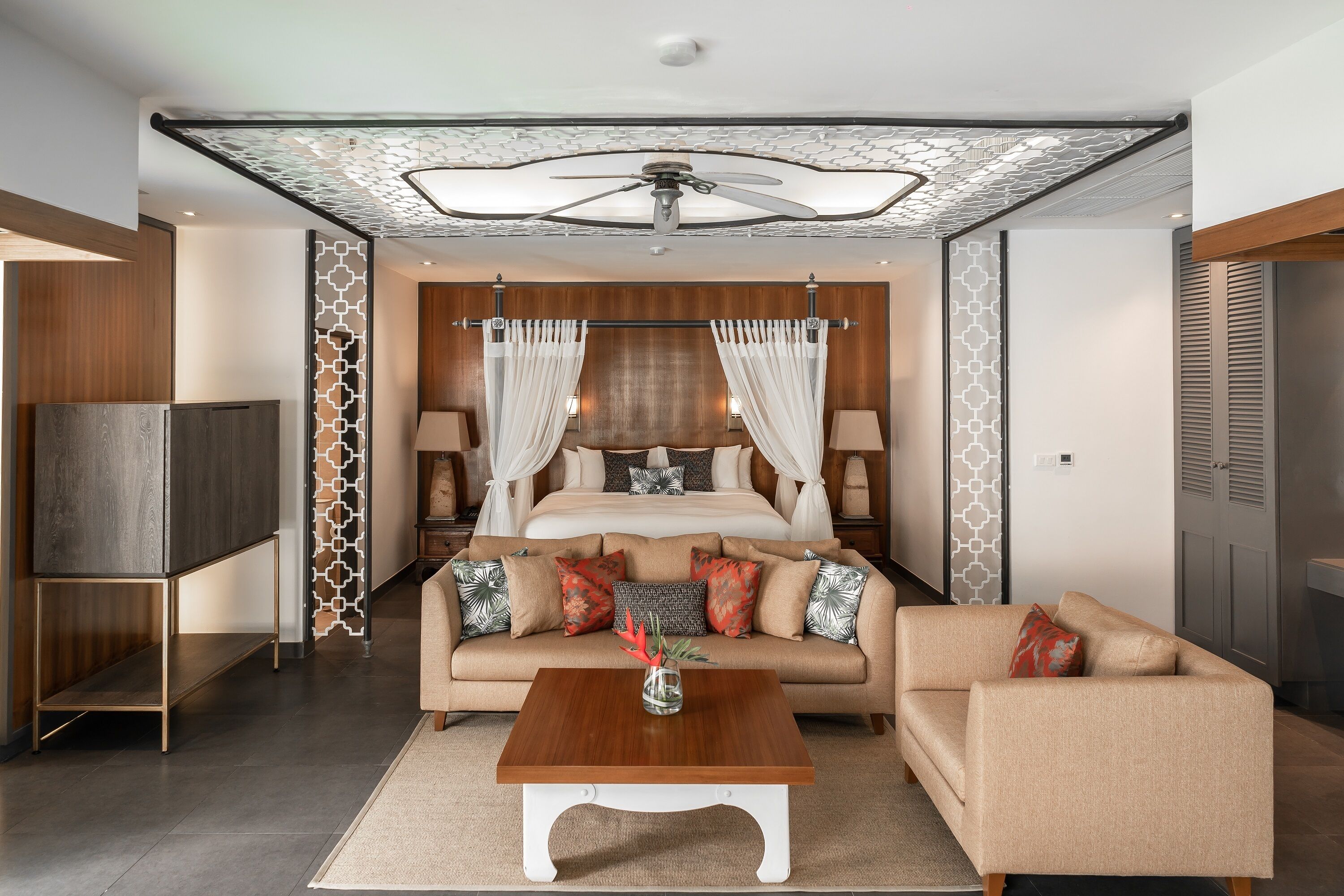 A modern bedroom with a large bed, a TV, and a coffee table.