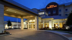 A Hilton Garden Inn with a modern entrance, large glass doors, and a well-lit facade. - Hilton Garden Inn Dallas/Arlington (Arlington)