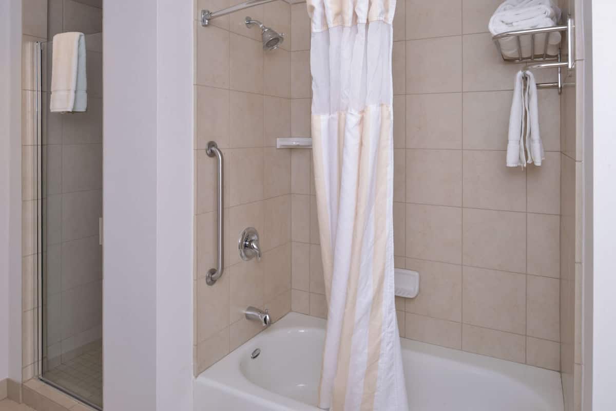 junior suite, 1 king bed | bathroom | combined shower/bathtub, free toiletries, hair dryer, towels