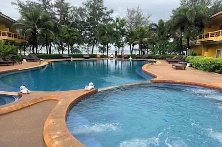 Outdoor pool, pool umbrellas. Bacchus Home Resort