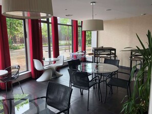Enjoy meals around the central round table surrounded by comfortable chairs in this inviting dining area.