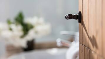A close-up of a wooden door with a metallic handle.