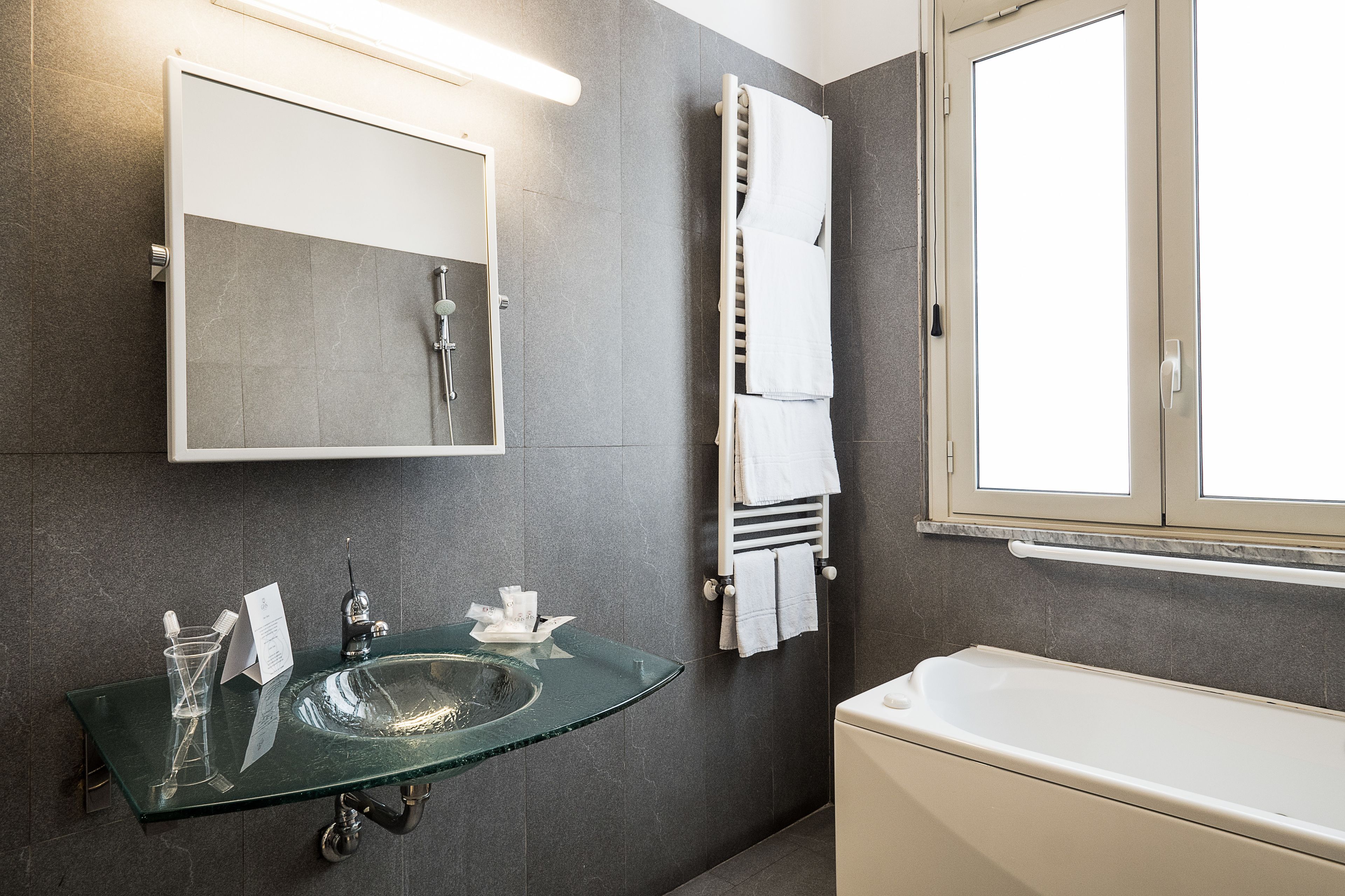superior double room | bathroom | combined shower/bathtub, rainfall showerhead, designer toiletries