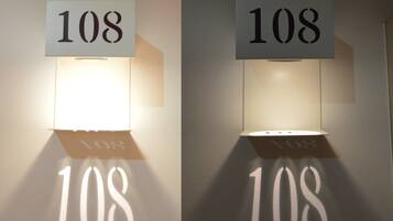 Two wall-mounted light fixtures with the number '108' displayed on them.
