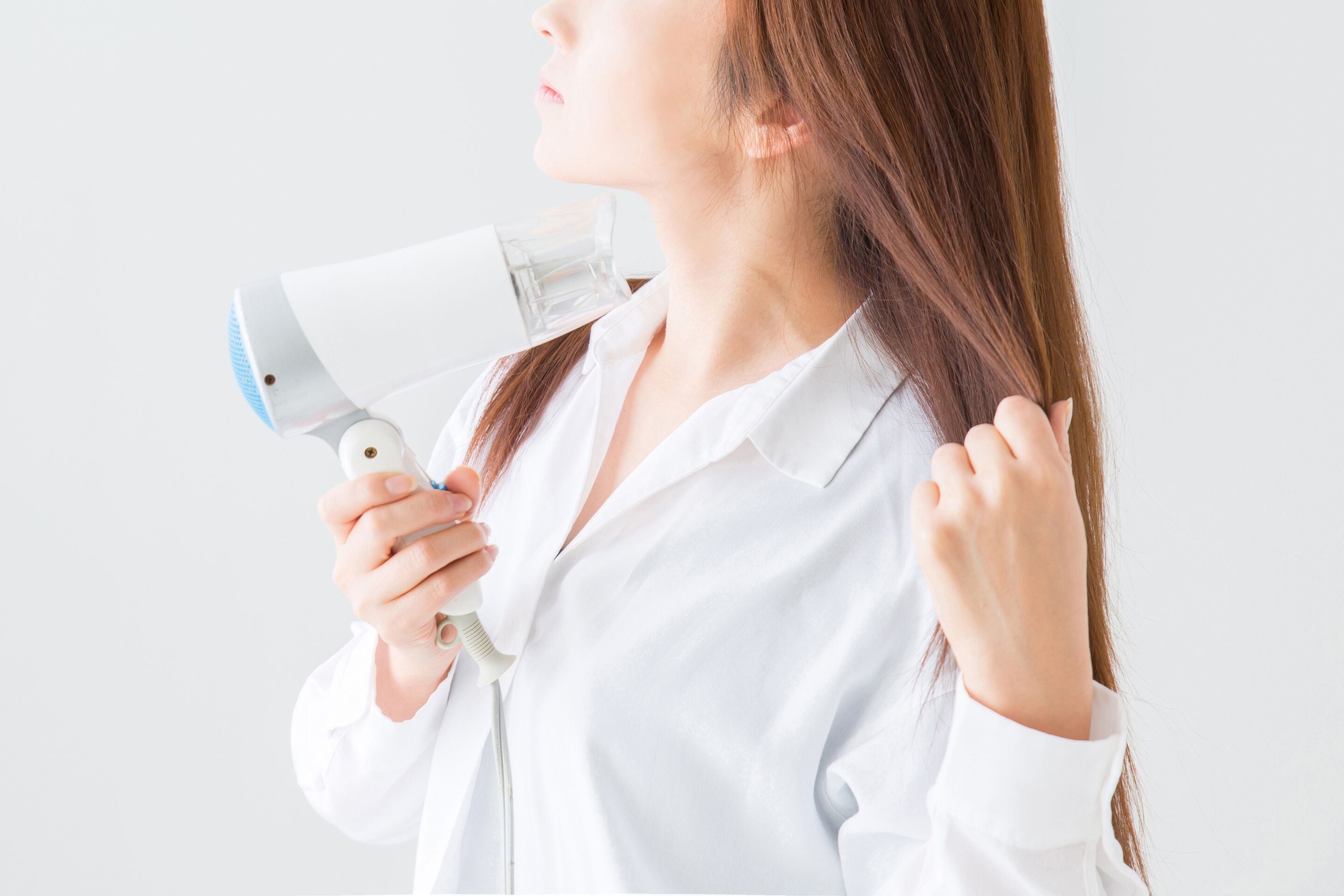 A person holding a hairdryer.