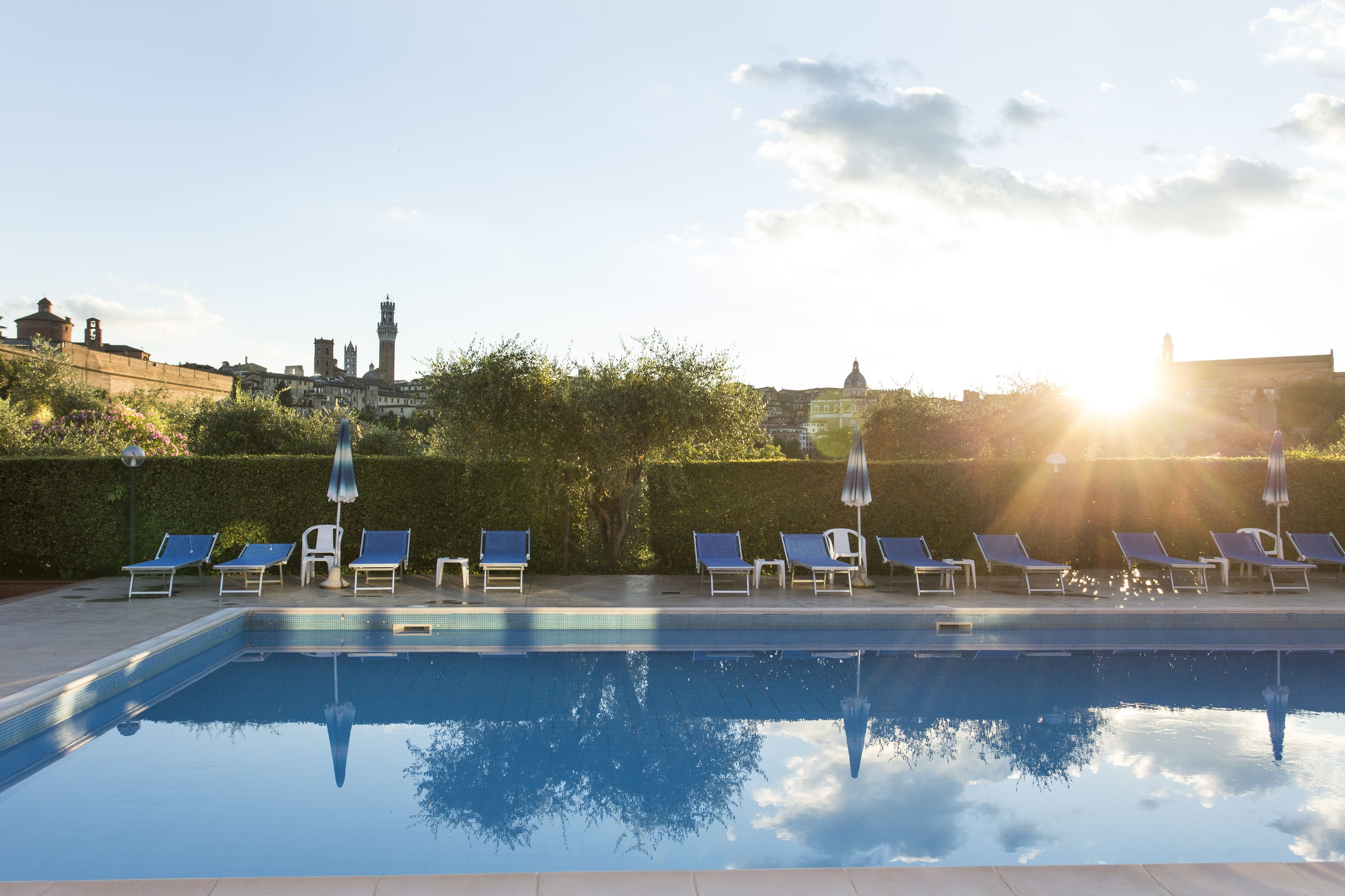 Seasonal outdoor pool, open 9:00 AM to 6:00 PM, pool umbrellas