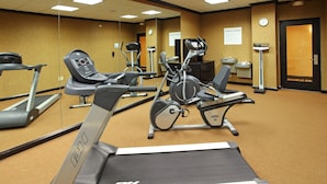 A fitness center with treadmills, stationary bikes, and elliptical machines.