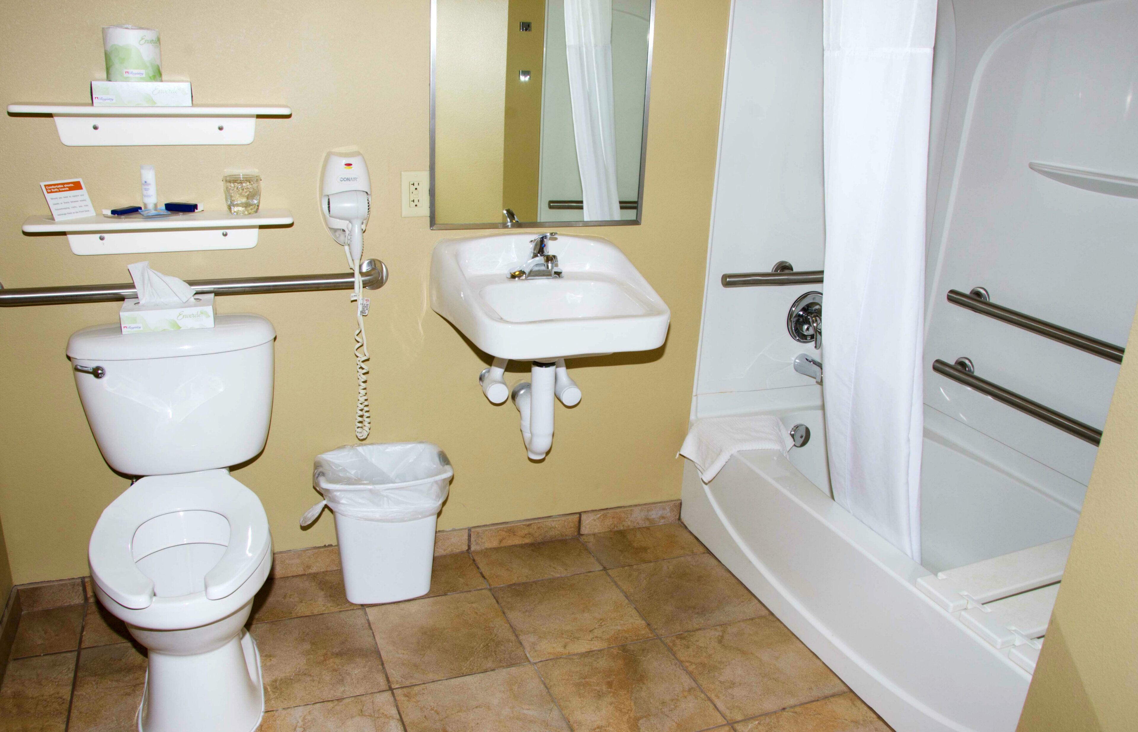 A bathroom with a toilet, sink, and bathtub.