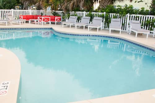 Outdoor pool, open 9:00 AM to 9:00 PM, pool umbrellas, pool loungers