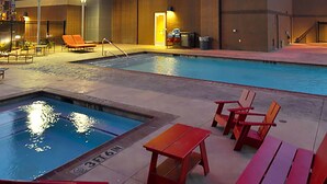 A hotel with a swimming pool, outdoor seating, and a well-lit facade. - Overton Hotel and Conference Center (Lubbock)