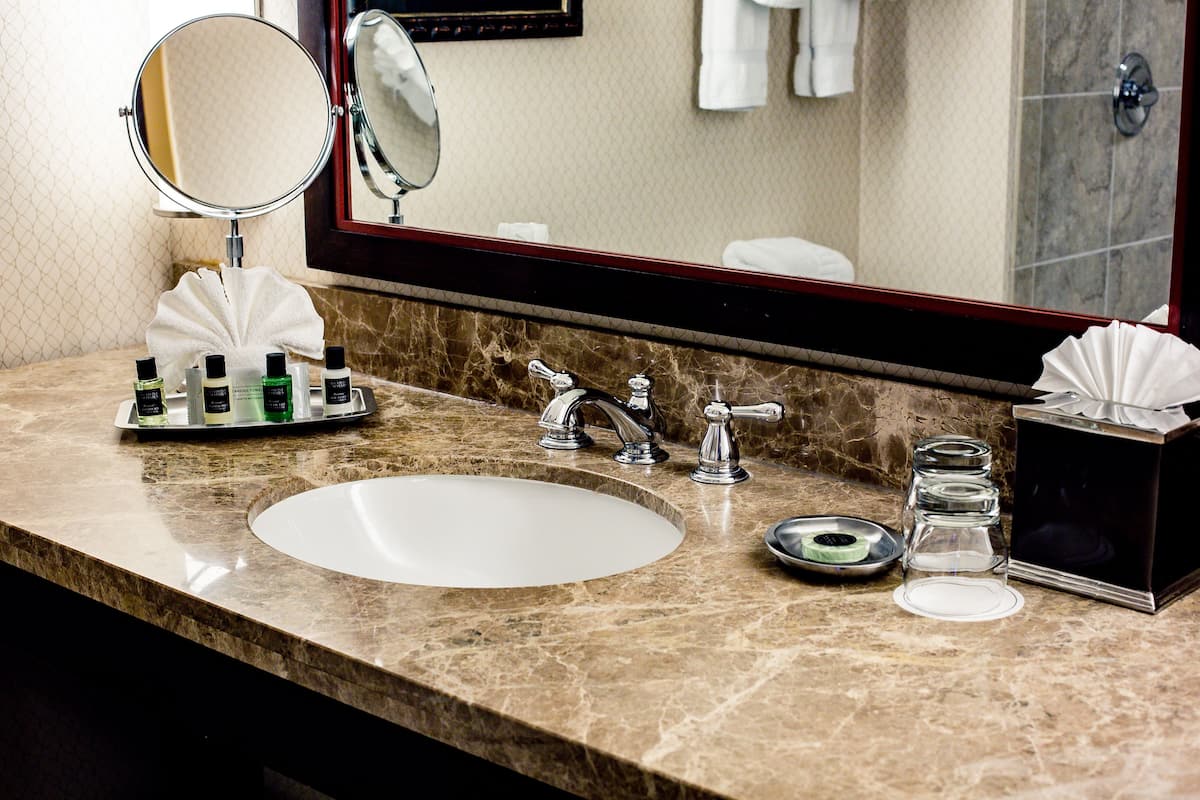 designer toiletries, hair dryer, towels, soap