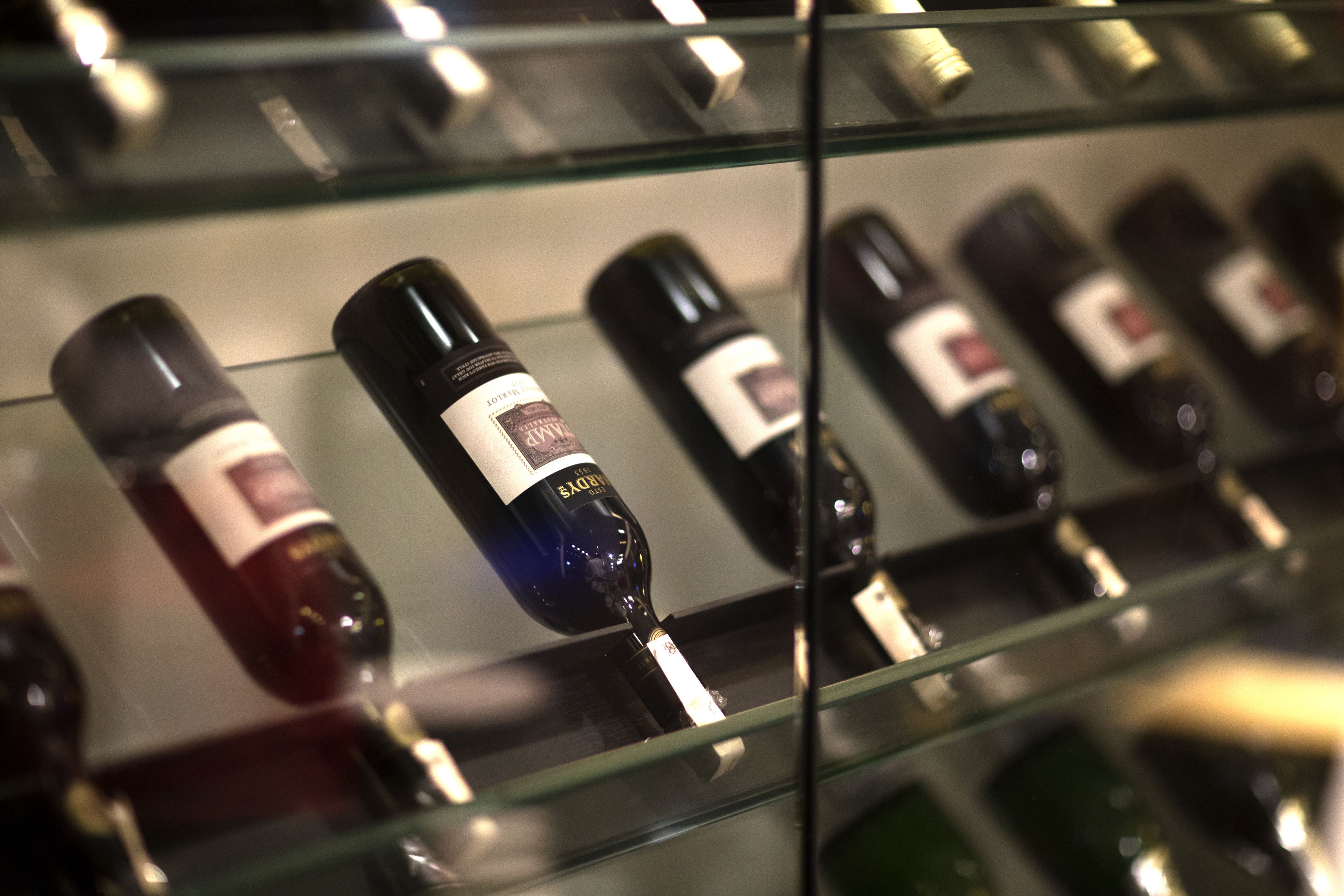 A display of wine bottles on shelves.