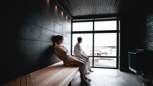 A modern interior with a wooden bench and a large window. - TanumStrand (Grebbestad)