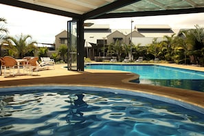Relax by the pool, surrounded by the hotel's sleek architecture.