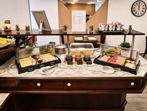 A buffet counter with various food items and condiments. - Bellevue Hotel (Düsseldorf)