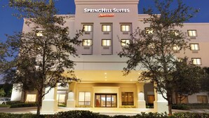 Ein Hotel mit moderner Fassade, zahlreichen Fenstern und einer auffälligen Beschilderung für SpringHill Suites Marriott.