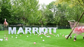 Welcome to the Marriott grounds, where a pink flamingo statue and vibrant balloons create a lively atmosphere.
