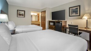 A hotel room with two beds, a desk, a chair, a TV, and a lamp. - Best Western Copper Hills Inn (Globe)