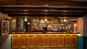 A bar with wooden paneling and a tiled floor. - Red Lion Todwick by Chef and Brewer Collection (Sheffield)