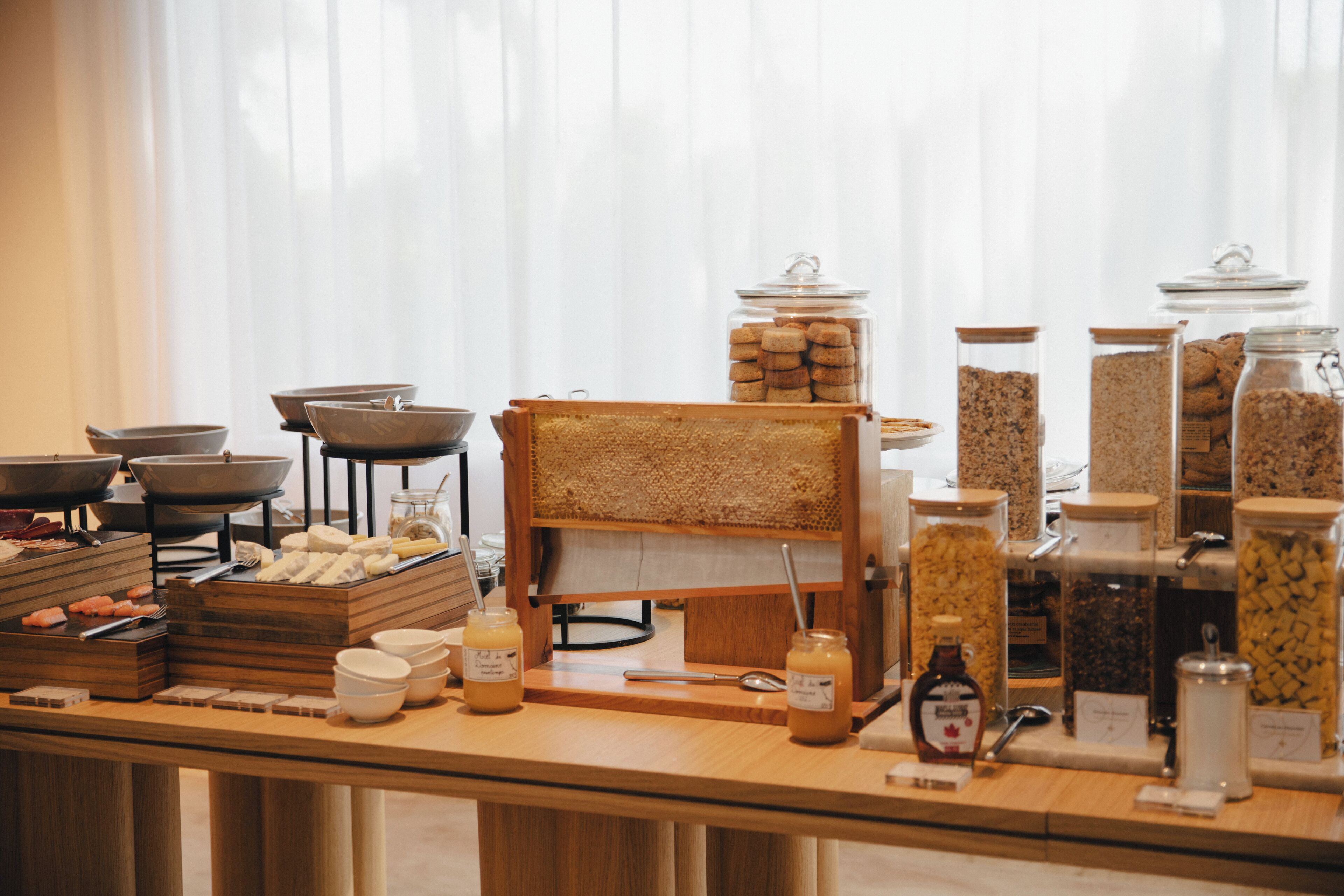 A buffet setup with various food items and condiments.