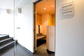 A modern interior with a glass door leading to a kitchen area. - TUI BLUE Schladming (Schladming)