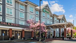 A Holiday Inn hotel with a covered entrance and a parking area. - Holiday Inn Hotel & Suites Surrey East Cloverdale by IHG (Surrey)