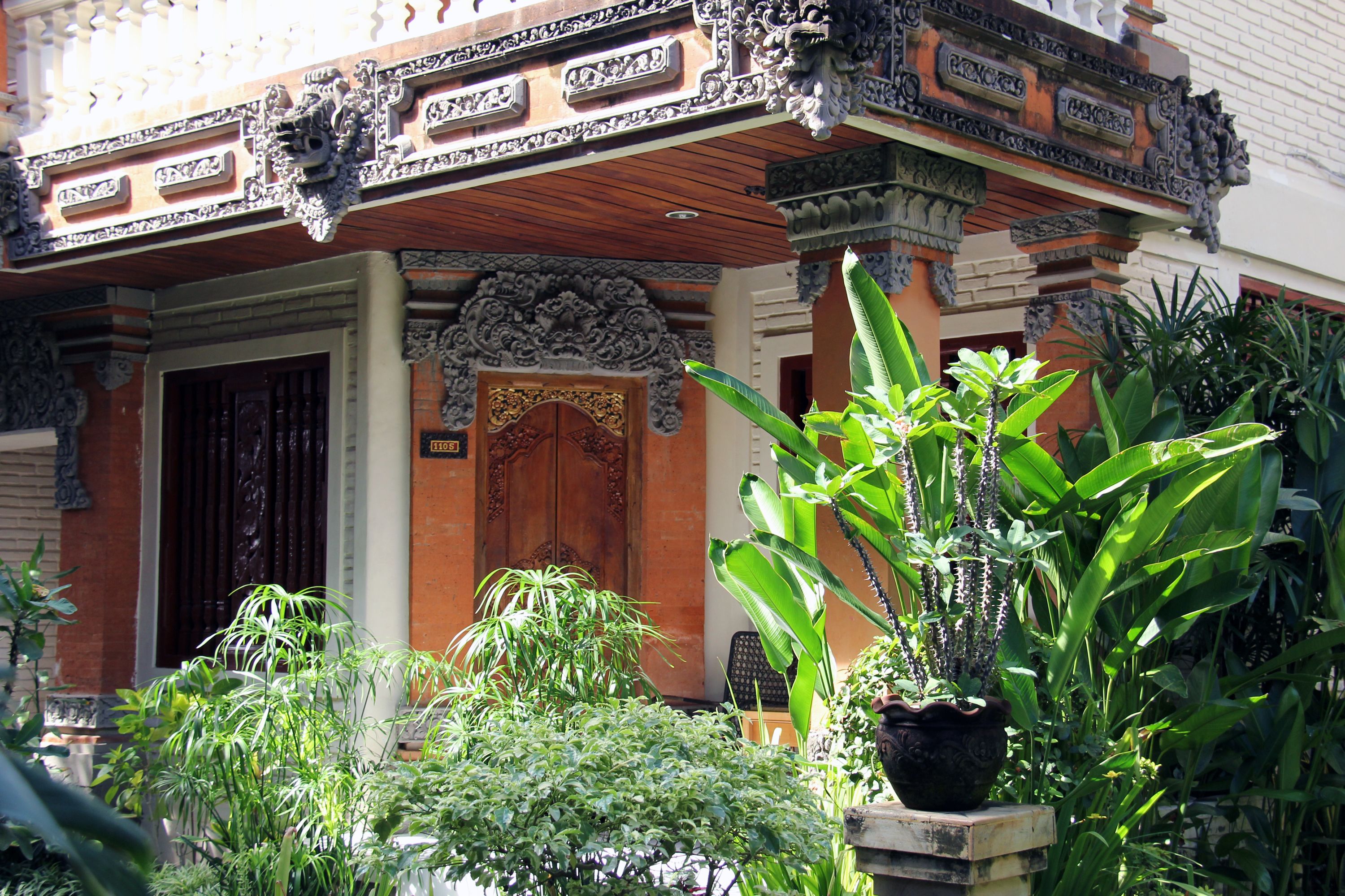 A traditional building with ornate carvings and a wooden door.
