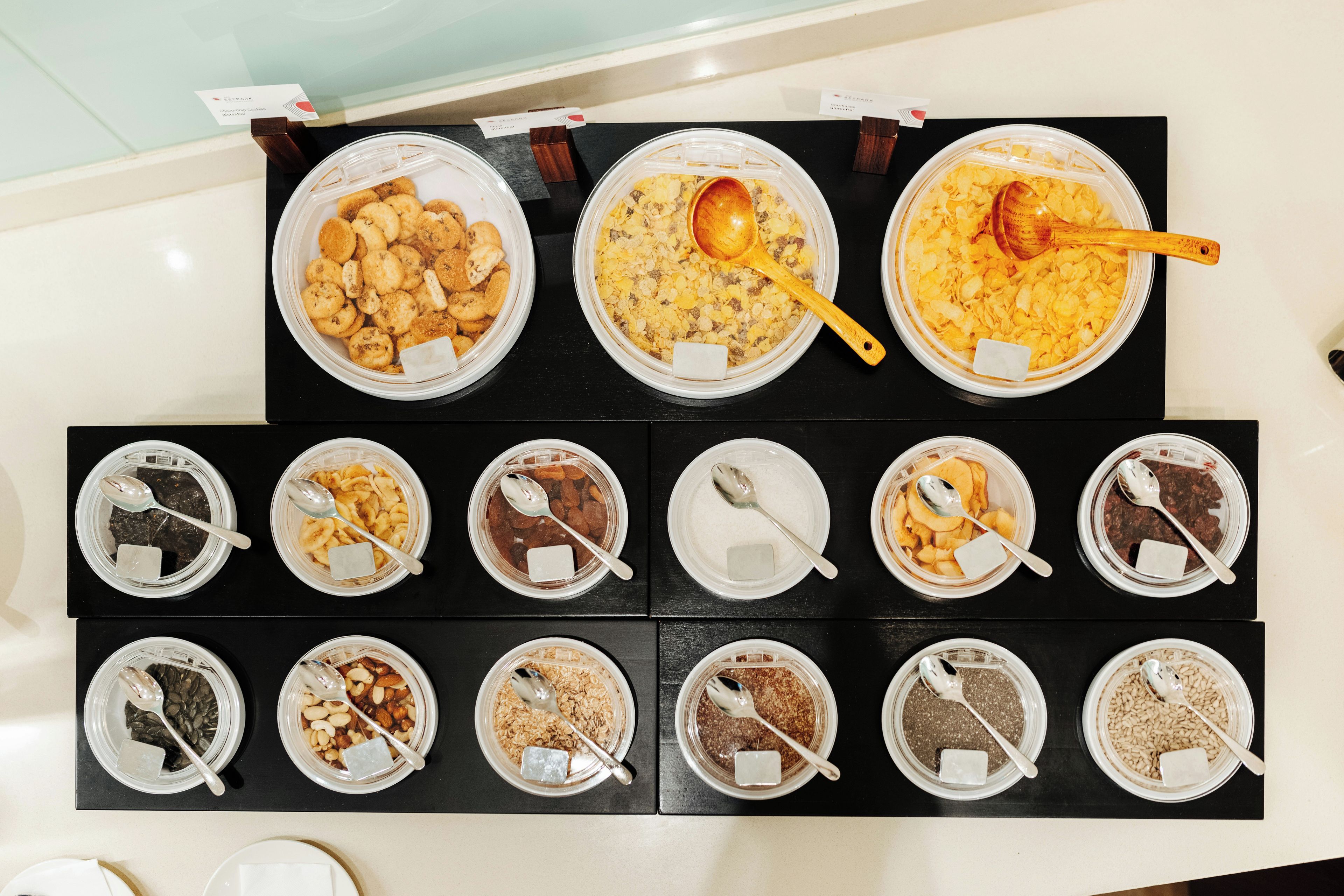 A variety of food items displayed in clear containers on a table.