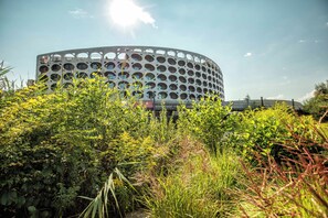 A modern building with a circular design and numerous circular windows.