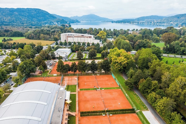 A tennis court with a building in the background.