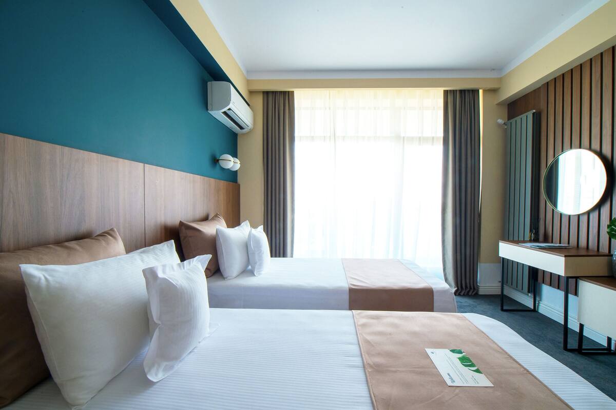 Twin Room | Minibar, in-room safe, desk, iron/ironing board (on request)