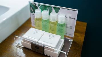 A display of toiletries including a bar of soap and bottles of lotion.