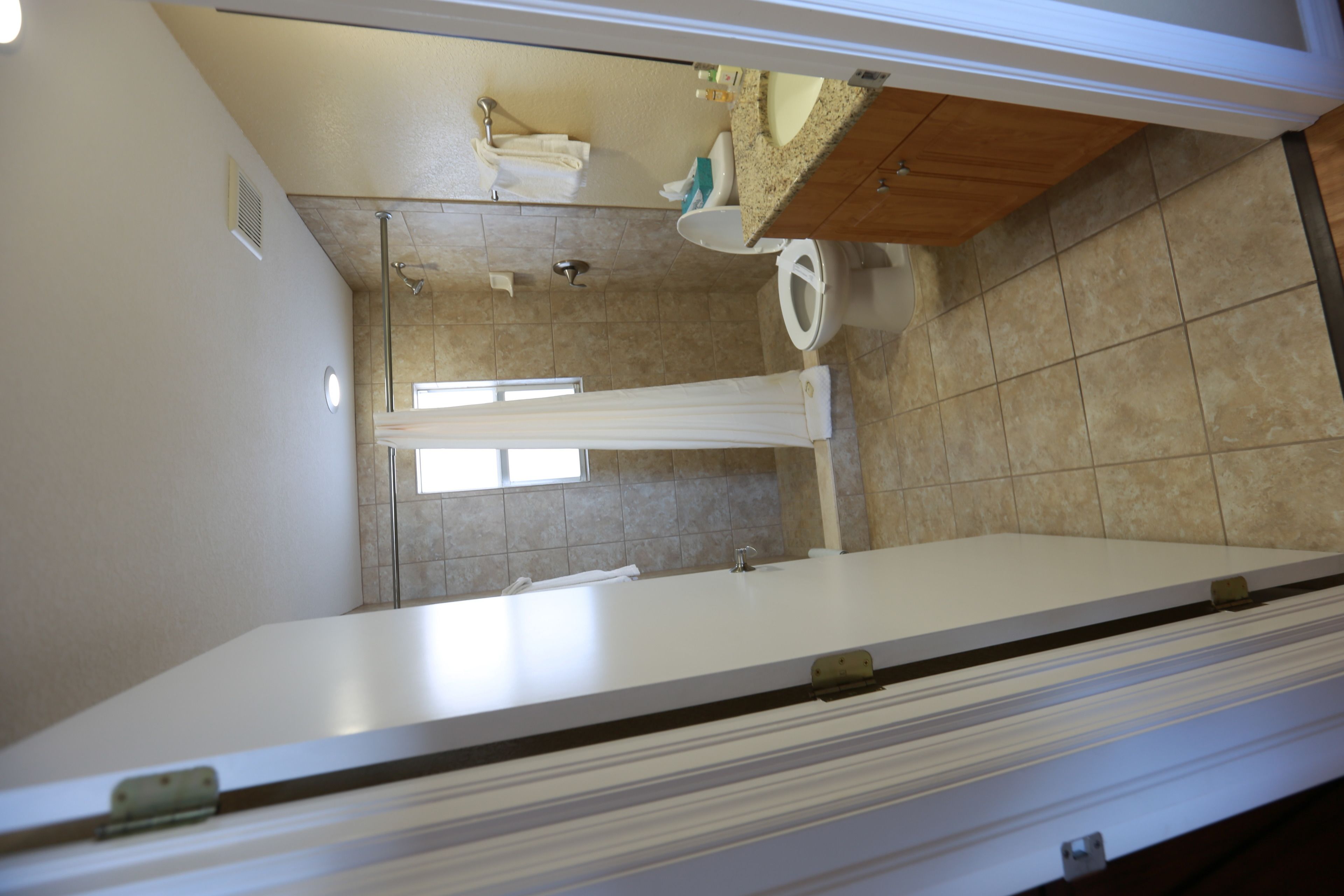 A bathroom with a bathtub, toilet, and sink.