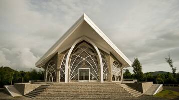 A modern building with a triangular roof and arched windows.