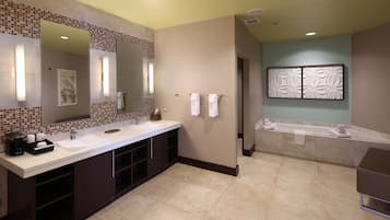 A modern bathroom with a large sink, a bathtub, and a shower area.