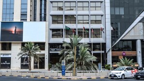 A modern hotel building with a prominent sign reading "Oasis Hotel". - Oasis Hotel Kuwait (Kuwait City)