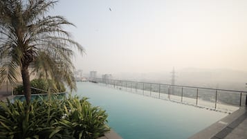 Outdoor pool, open 6 AM to 8 PM, pool umbrellas, pool loungers