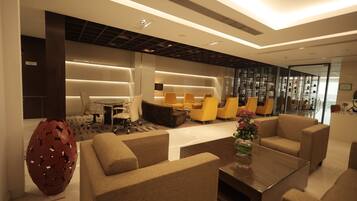 A modern living room with sofas, a coffee table, and a decorative egg sculpture.