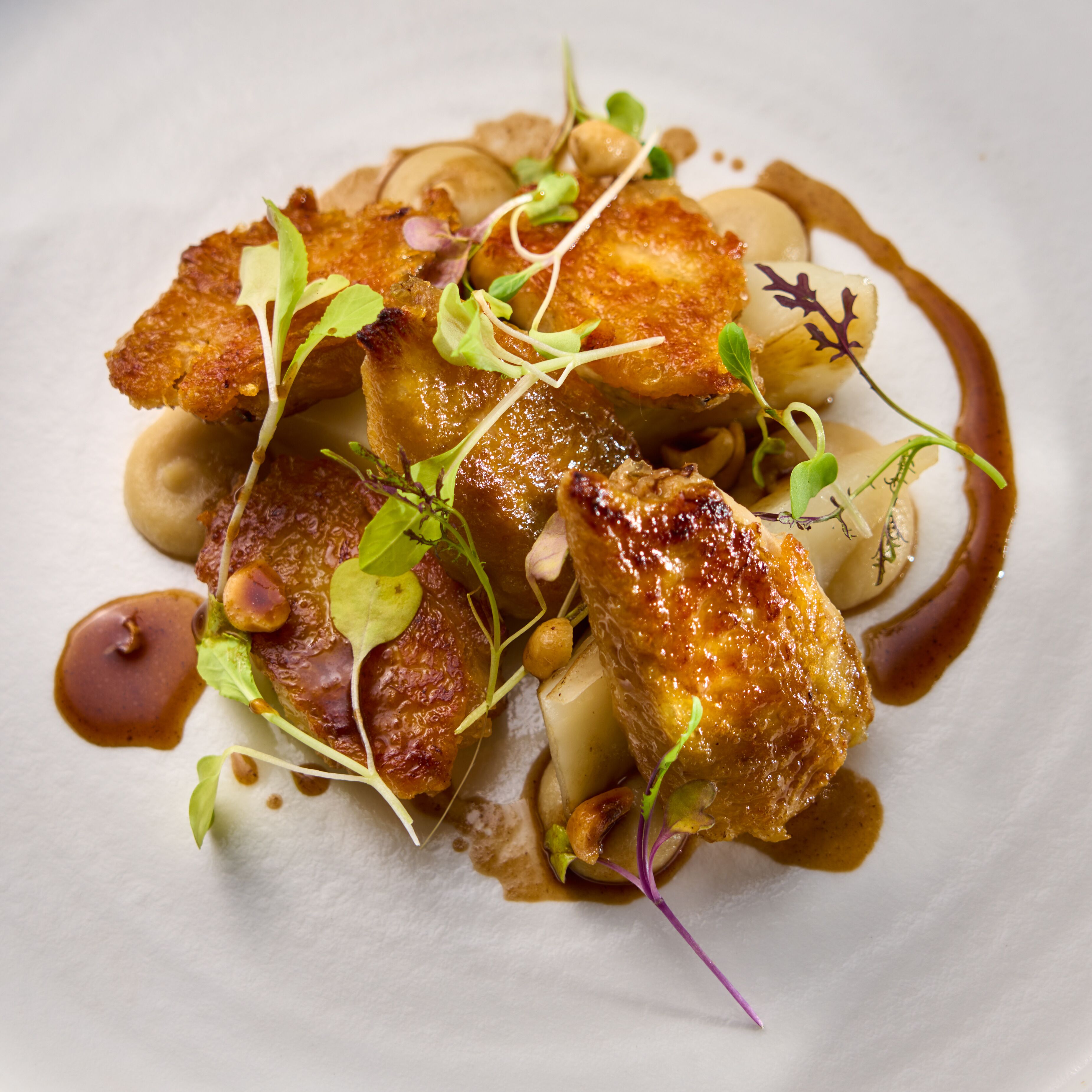 A plated dish with various food items and garnishes.