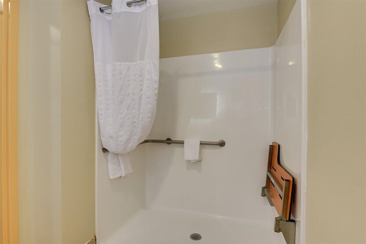suite, 1 king bed with sofa bed, accessible, non smoking (w/ roll-in shower) | bathroom | combined shower/bathtub, hair dryer, towels
