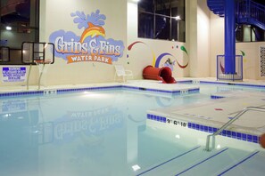 An indoor swimming pool with a sign reading 'Gins & Fins Water Park'.