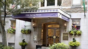 The exterior of a hotel with a sign reading "1006 Spring Street" and "INN" on the entrance. - The Inn at Virginia Mason (Seattle)