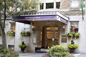 The exterior of a hotel with a sign reading "1006 Spring Street" and "INN" on the entrance.