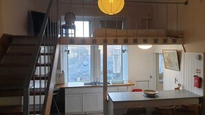 A kitchen with a window, a sink, and a dining area with chairs. - The Georgian House Hotel (Glasgow)