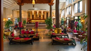 A spacious lobby with multiple seating areas, large windows, and a central reception desk. - Angkor Miracle Resort & Spa (Siem Reap)