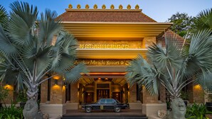 A building with a traditional architectural style, featuring a tiled roof and a sign with text. - Angkor Miracle Resort & Spa (Siem Reap)