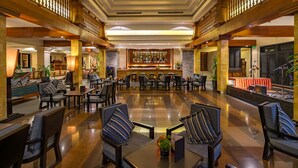 A spacious lobby with a bar area, seating arrangements, and a stage for events. - Angkor Miracle Resort & Spa (Siem Reap)